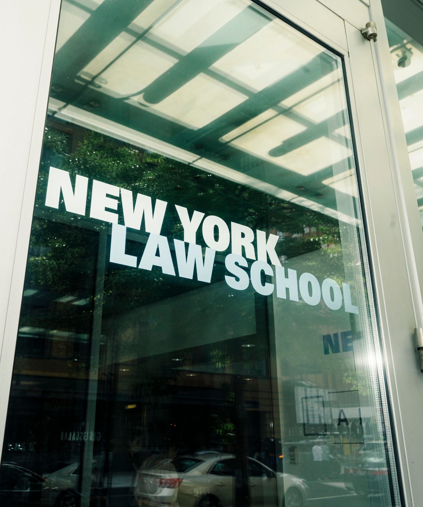 View of a front glass door of New York Law School, showing the logo.