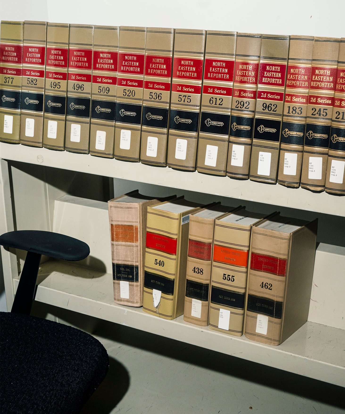 Close up view of shelves with several numbered volumes of books in a law library.